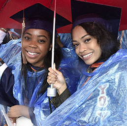 Morgan State graduates under an umbrella